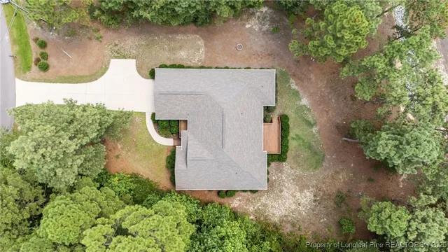 an aerial view of a house with a yard