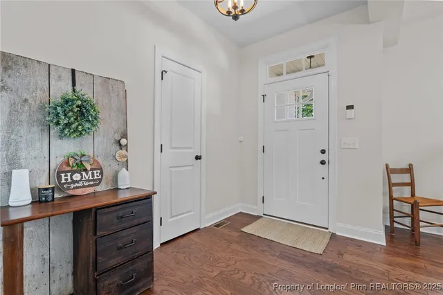 a view of an entryway with wooden floor
