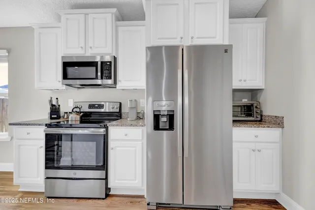 a bathroom with a granite countertop sink a large mirror and a vanity