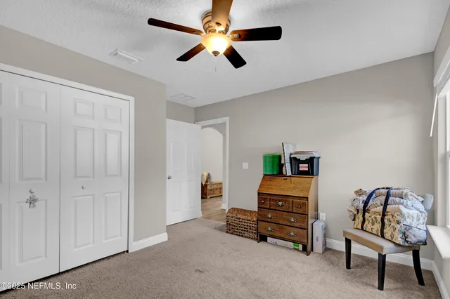 a bathroom with a granite countertop sink toilet and a mirror