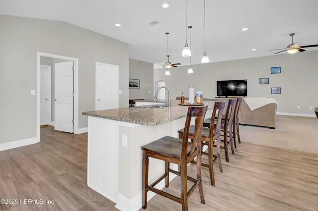 a view of a hallway with wooden floor and closet