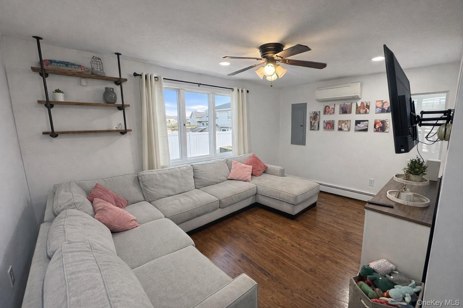 611 W Road Queens, NY 11693 - Photo 3 of 8 a living room with furniture and wooden floor