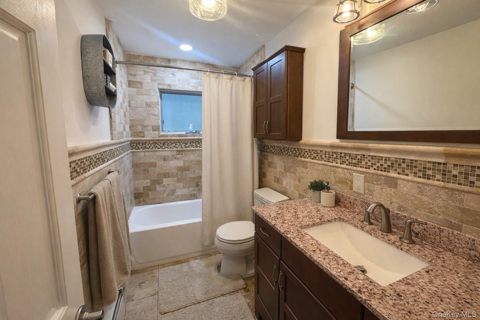611 W Road Queens, NY 11693 - Photo 4 of 8 a bathroom with a granite countertop sink toilet and shower