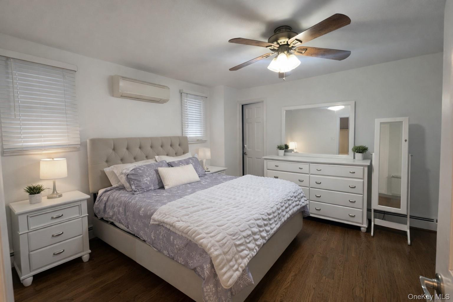 611 W Road Queens, NY 11693 - Photo 8 of 8 a bedroom with a bed and a chandelier