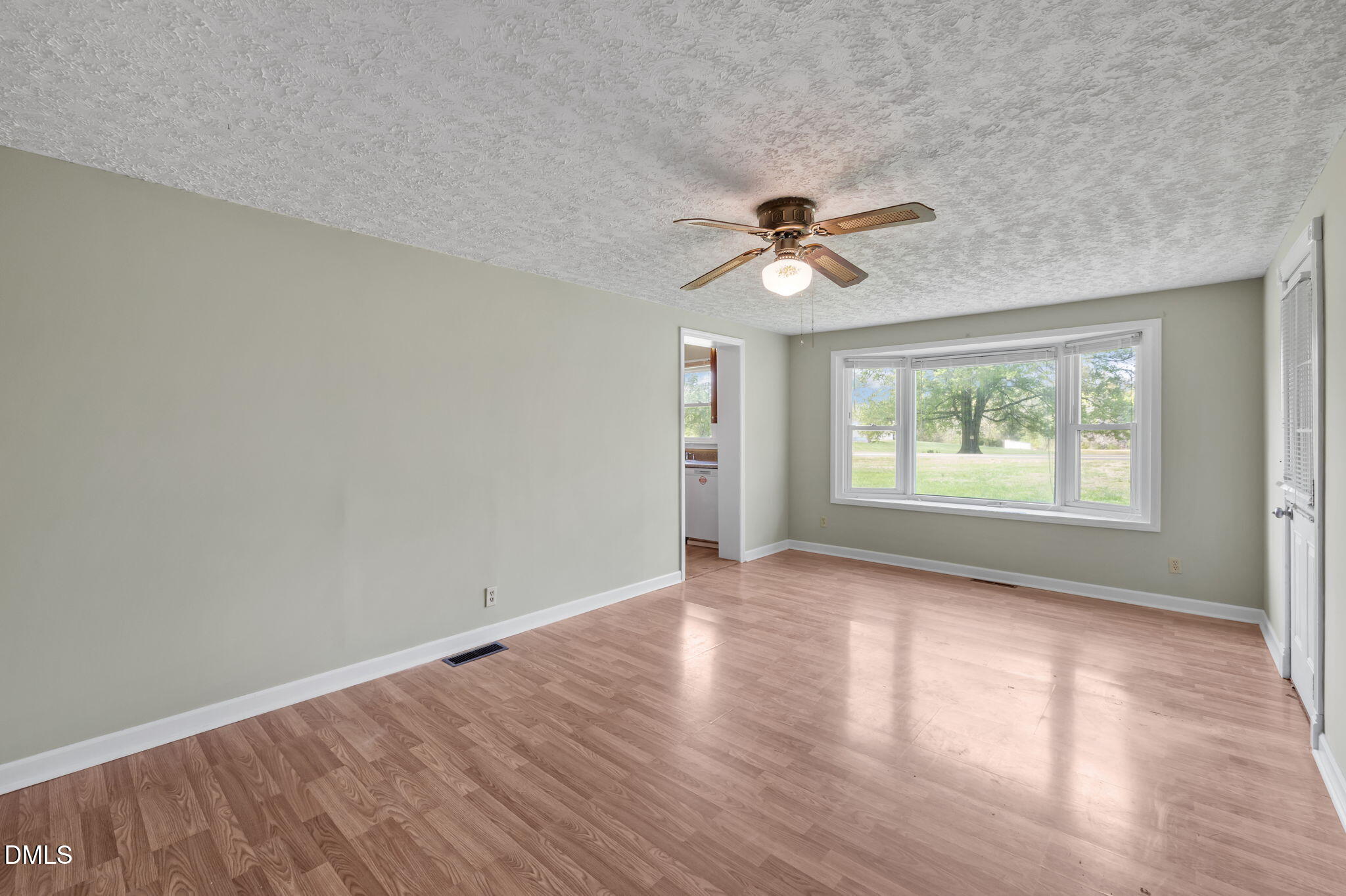95 Harold Gill Road Roxboro, NC 27574 - Photo 12 of 53 wooden floor in an empty room with a window