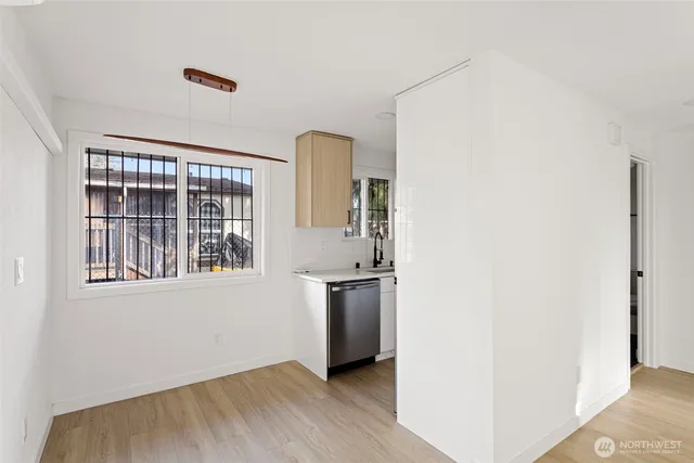 a view of a kitchen with wooden floor and windows