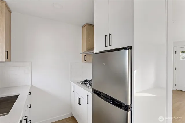 a kitchen with a sink and a refrigerator