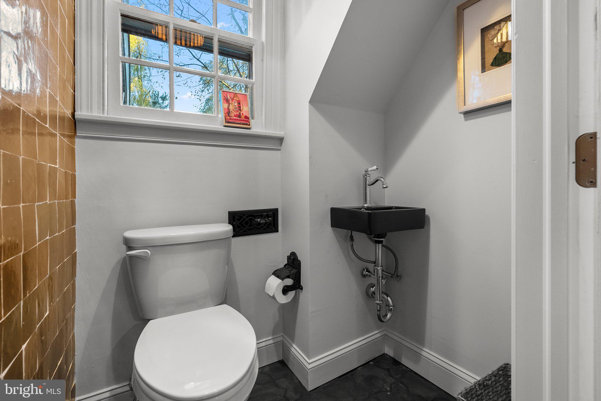 12 Chestnut Lane Wayne, PA 19087 - Photo 38 of 52 a white toilet sitting next to a bathroom sink