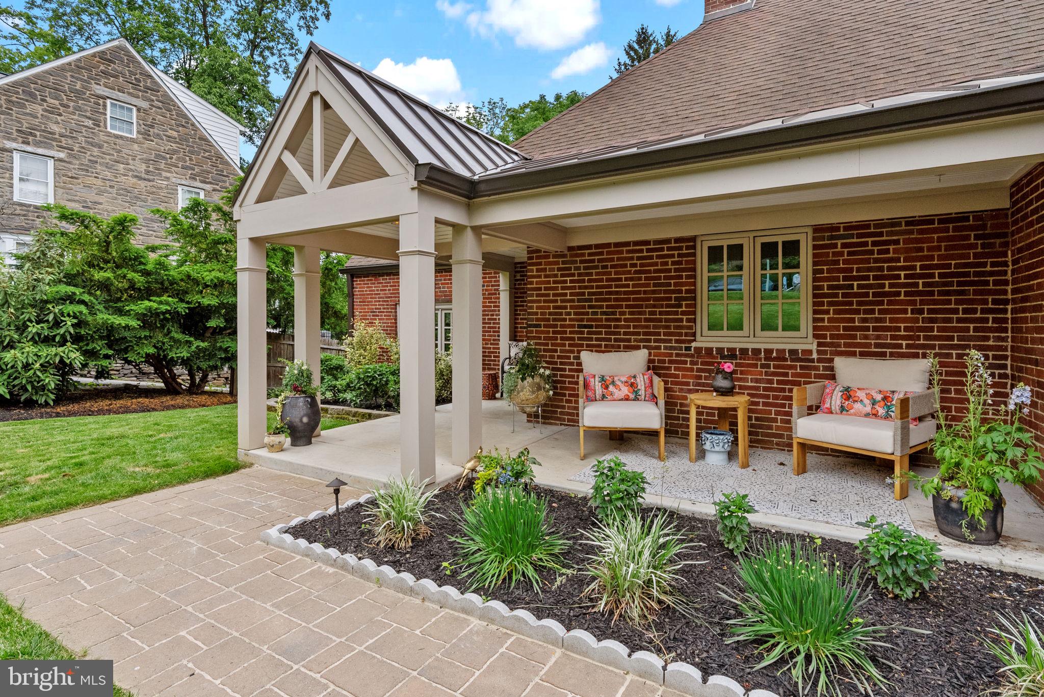 12 Chestnut Lane Wayne, PA 19087 - Photo 4 of 52 a backyard of a house with garden and outdoor seating