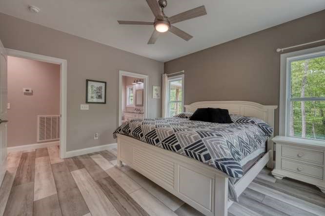 478 Flat Top Road Young Harris, GA 30582 - Photo 32 of 75 a bedroom with a large bed chandelier and a window