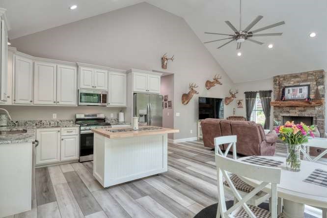 478 Flat Top Road Young Harris, GA 30582 - Photo 4 of 75 a kitchen with stainless steel appliances kitchen island granite countertop a stove top oven a sink a dining table and chairs