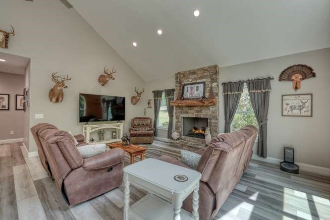 478 Flat Top Road Young Harris, GA 30582 - Photo 50 of 75 a living room with furniture a flat screen tv and a fireplace
