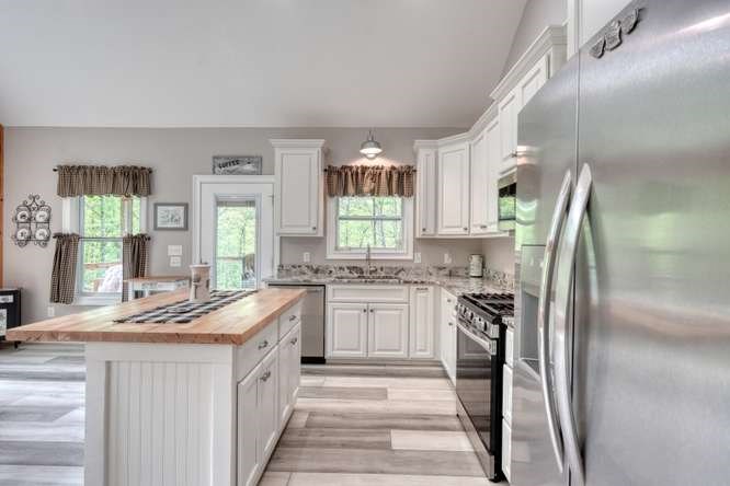 478 Flat Top Road Young Harris, GA 30582 - Photo 56 of 75 a kitchen with stainless steel appliances granite countertop a sink stove and refrigerator