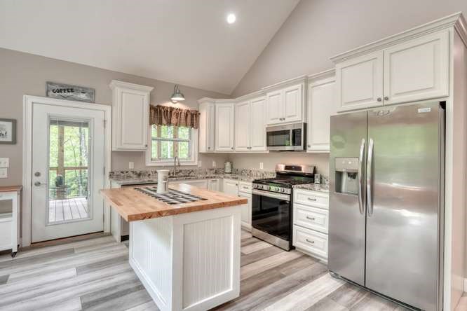478 Flat Top Road Young Harris, GA 30582 - Photo 57 of 75 a kitchen with a stove a sink and a refrigerator