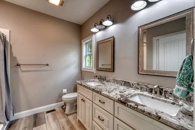 478 Flat Top Road Young Harris, GA 30582 - Photo 6 of 75 a bathroom with a granite countertop sink mirror and toilet