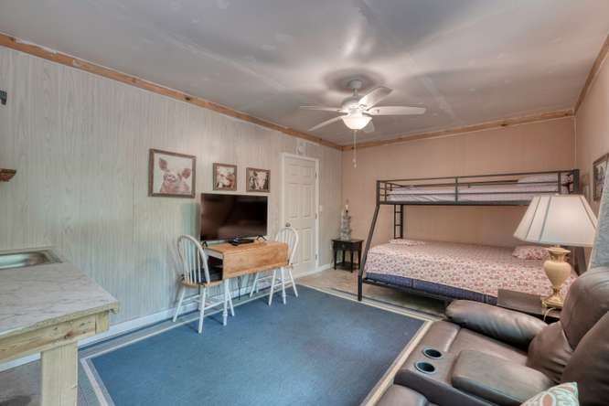 478 Flat Top Road Young Harris, GA 30582 - Photo 61 of 75 a bedroom with furniture and a chandelier