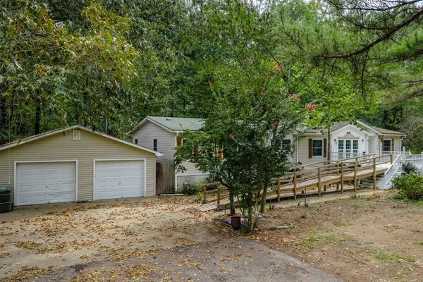 a house that has a tree in front of it