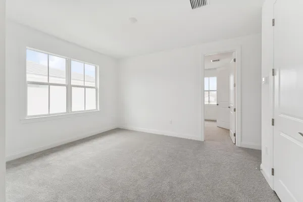 an empty room with windows and closet
