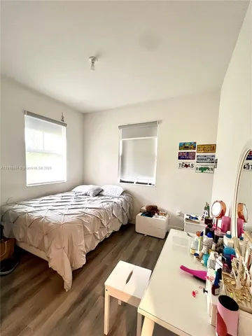 a bedroom with bed and a window