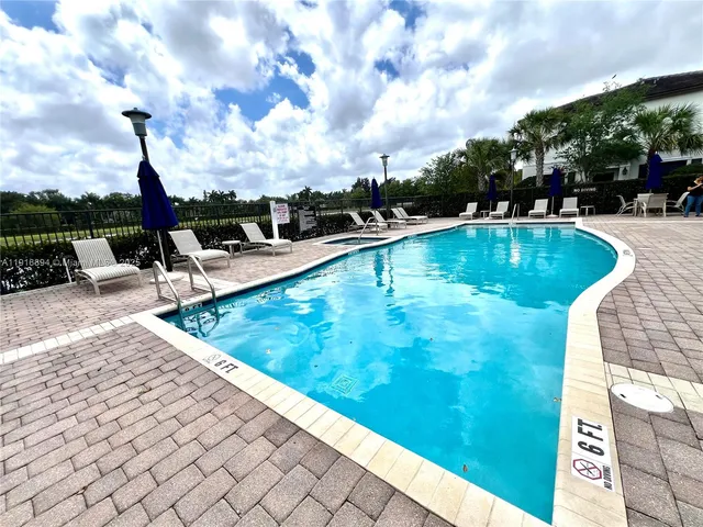 a view of swimming pool with chairs