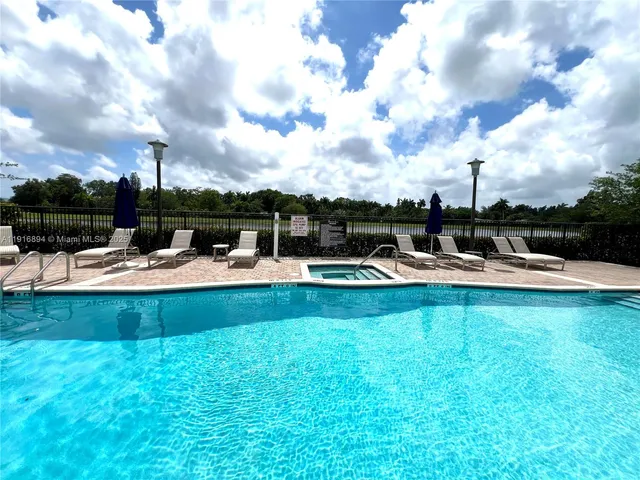 a swimming pool with outdoor seating yard and barbeque oven