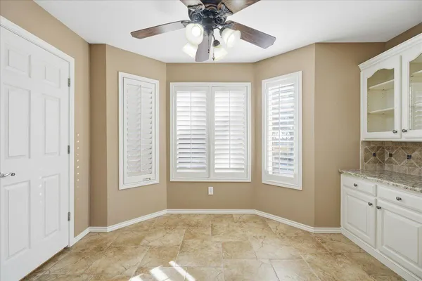 a spacious bathroom with a bathtub a mirror a vanity and a shower