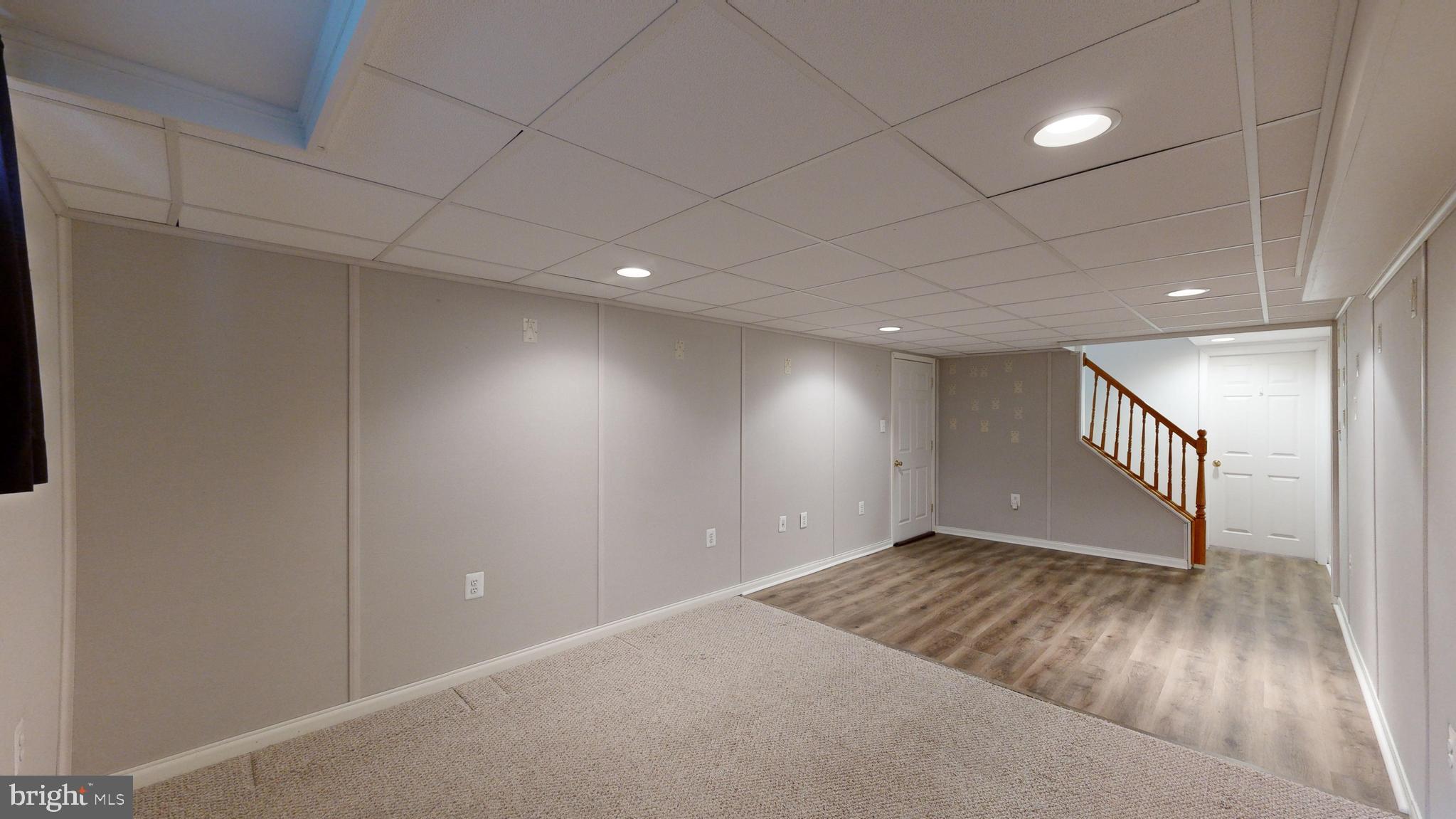 1101 White Oak Road Dover, DE 19901 - Photo 14 of 36 an empty room with wooden floor and windows