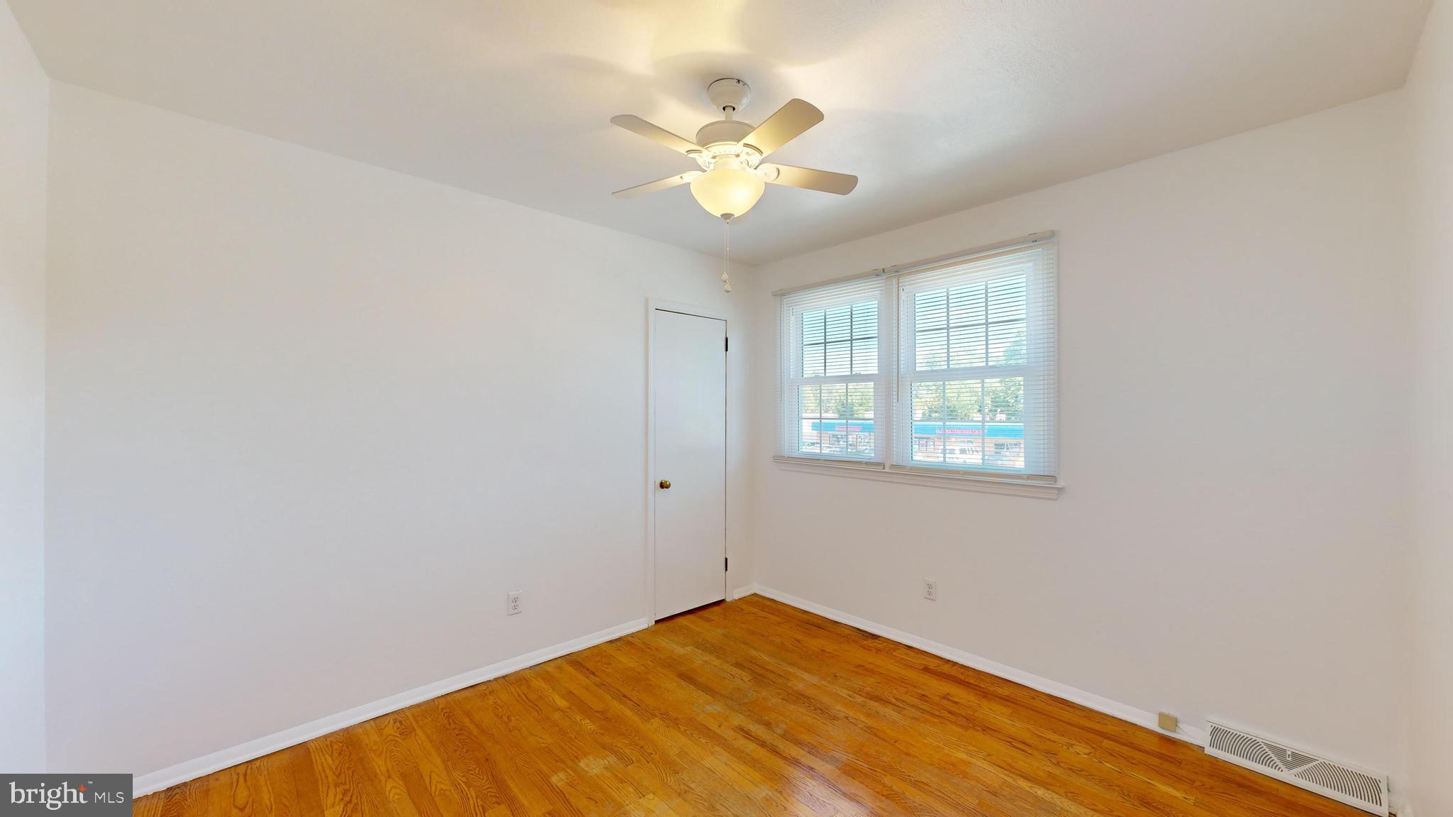 1101 White Oak Road Dover, DE 19901 - Photo 22 of 36 an empty room with a window and a ceiling fan
