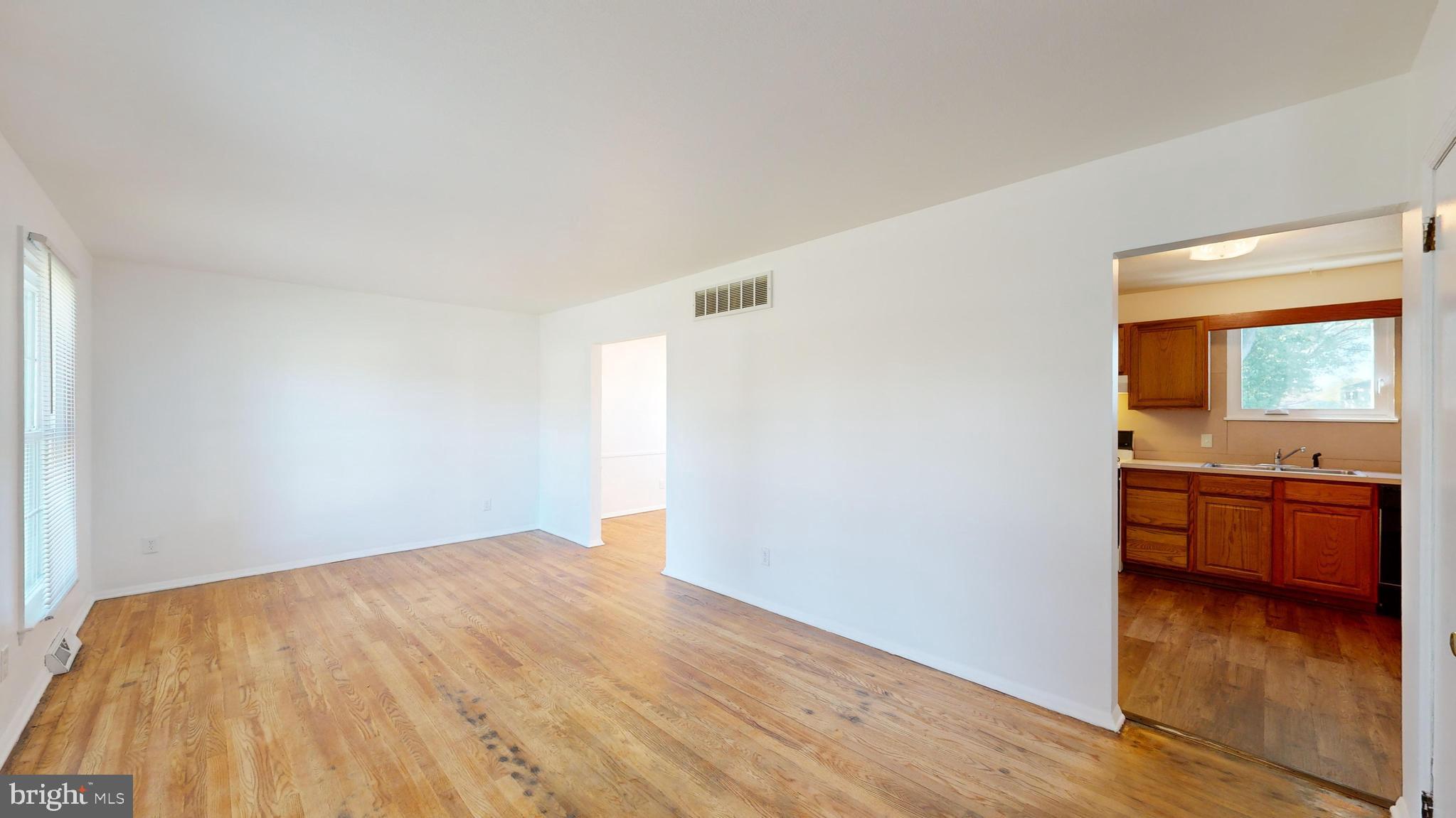 1101 White Oak Road Dover, DE 19901 - Photo 4 of 36 wooden floor in an empty room with a window