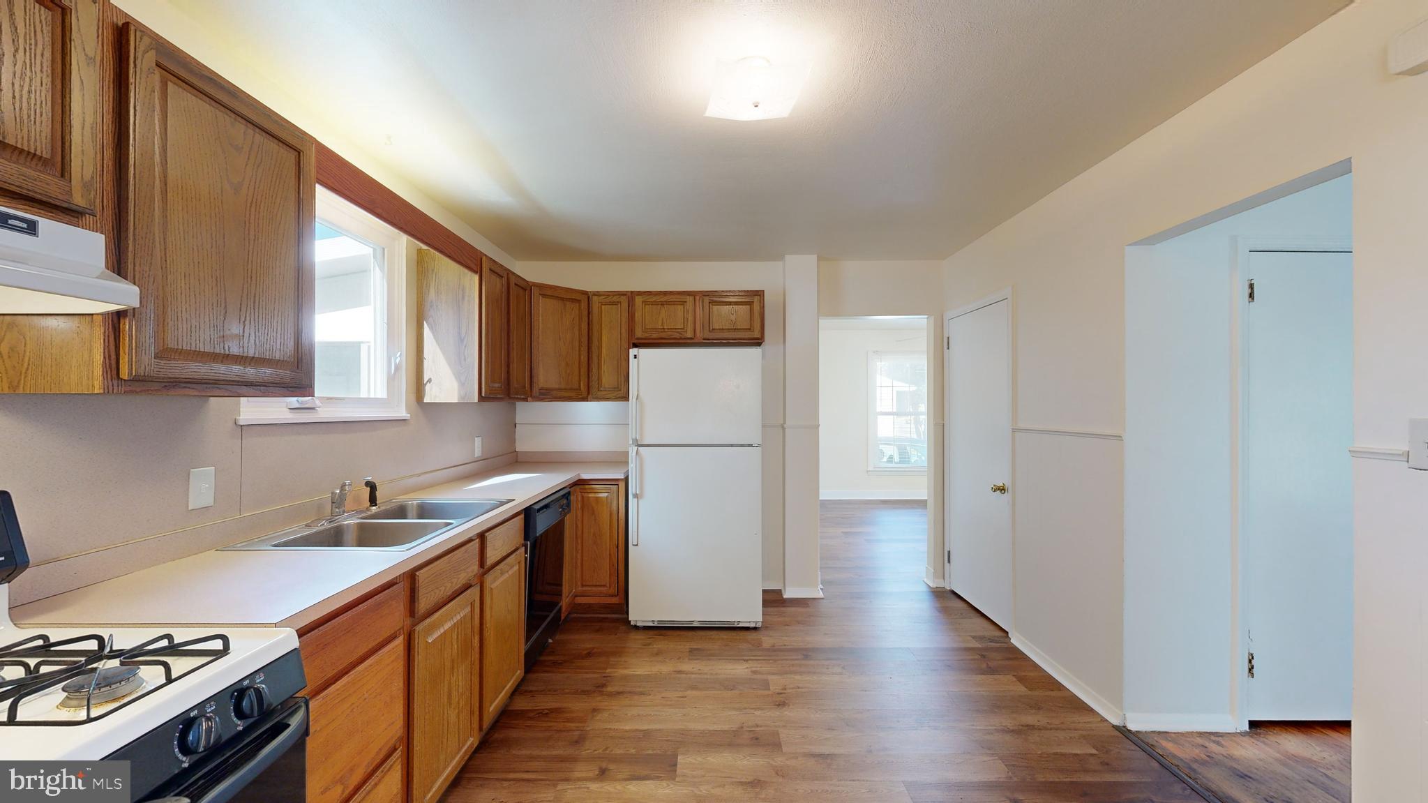 1101 White Oak Road Dover, DE 19901 - Photo 5 of 36 a kitchen with a sink a refrigerator and cabinets