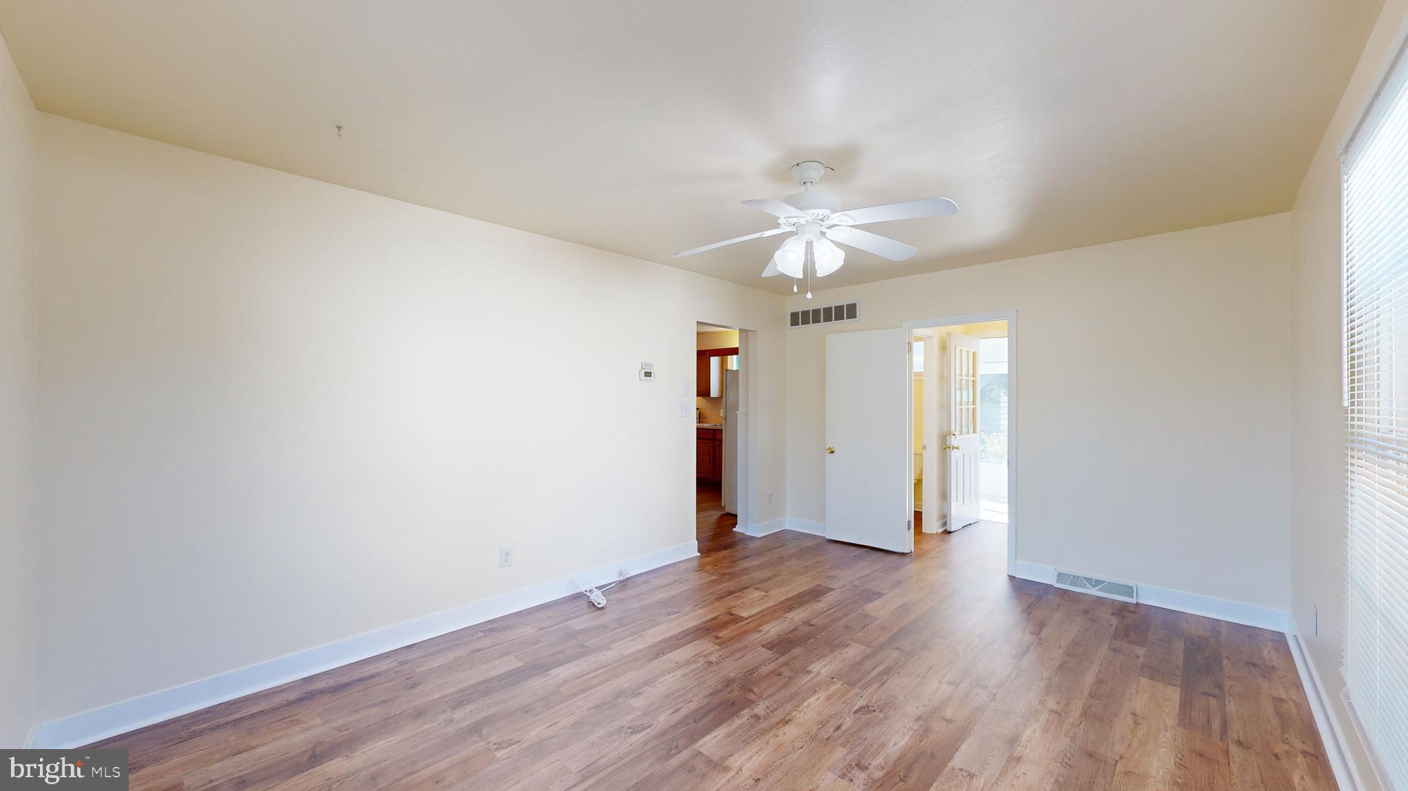 1101 White Oak Road Dover, DE 19901 - Photo 10 of 36 an empty room with wooden floor and window