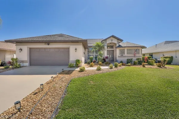 a front view of a house with a yard and garage