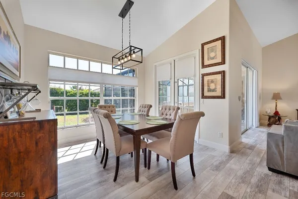 a view of a dining room with furniture wooden floor and a chandelier
