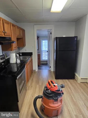 a kitchen with stainless steel appliances granite countertop a refrigerator and a stove