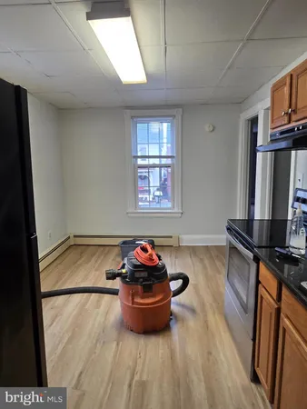 a room with wooden floor and furniture