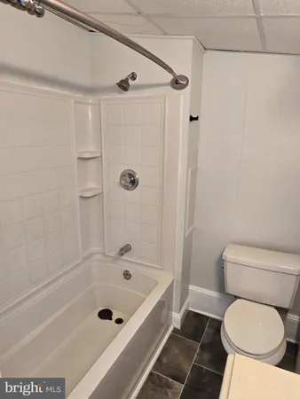 a bathroom with a toilet and a bathtub