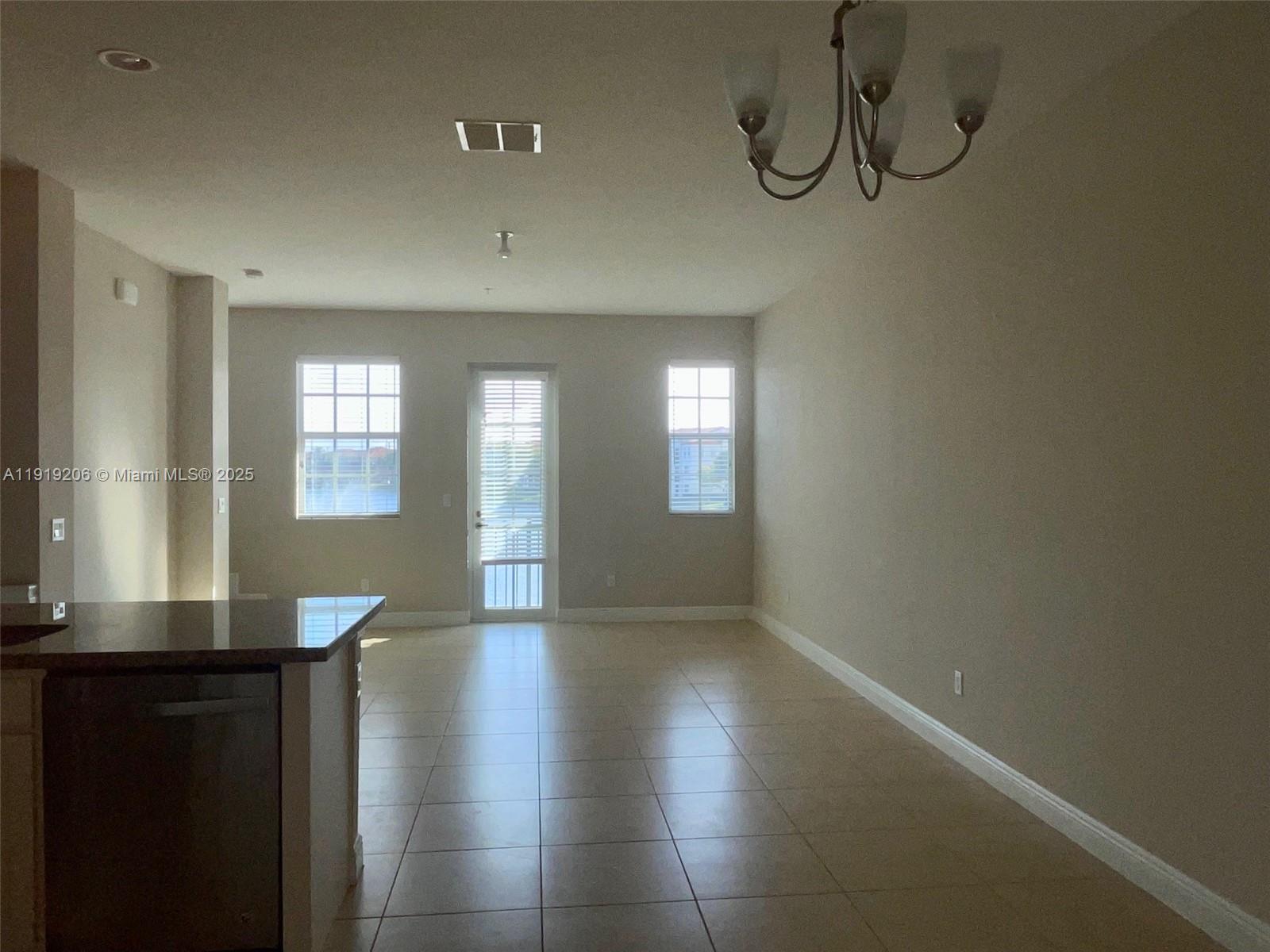 2929 Southwest 119th Way, Unit 2929 Miramar, FL 33025 - Photo 11 of 26 a view of livingroom and dining room with chandelier fan