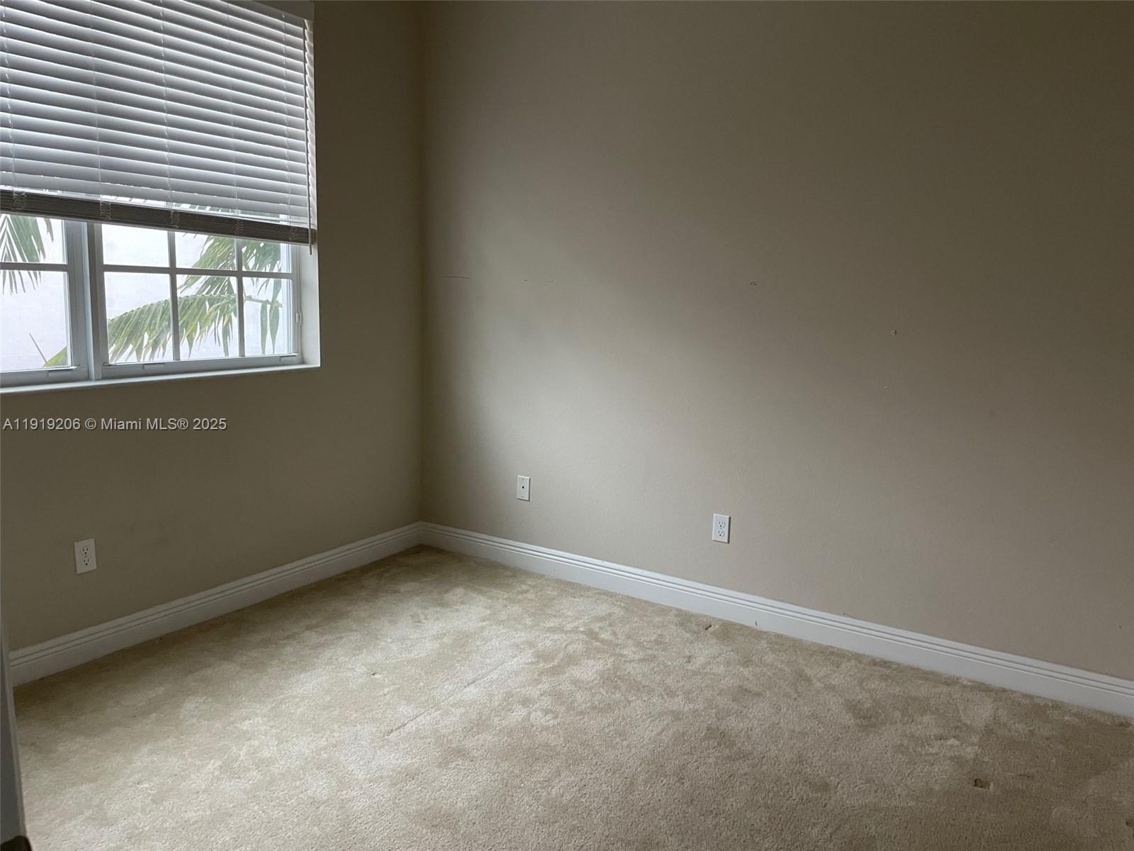 2929 Southwest 119th Way, Unit 2929 Miramar, FL 33025 - Photo 12 of 26 an empty room with a window