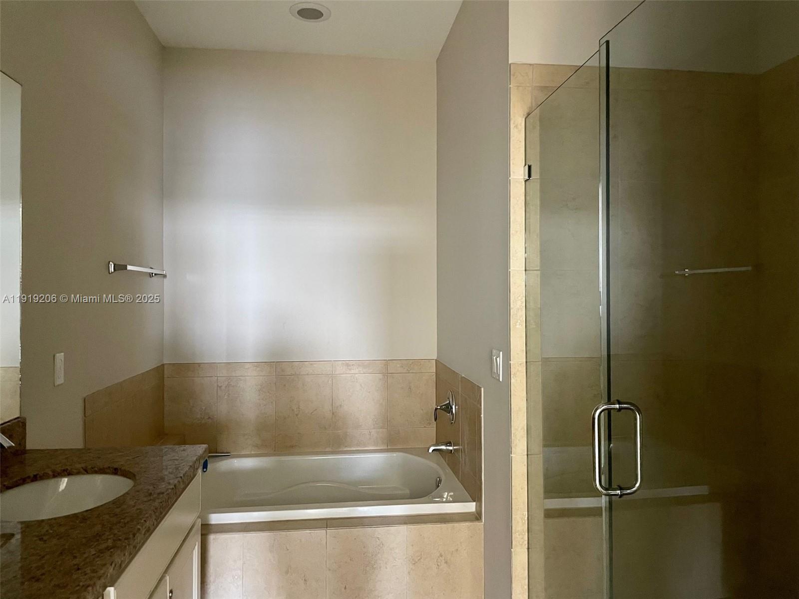 2929 Southwest 119th Way, Unit 2929 Miramar, FL 33025 - Photo 17 of 26 a bathroom with a granite countertop sink and a mirror