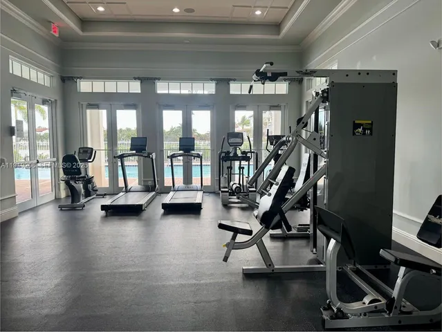 a living room with a sink a mirror and a flat screen tv