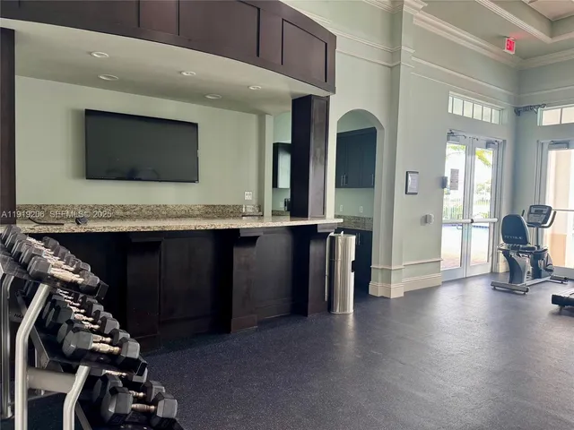 a palm tree sitting in front of a building with palm trees