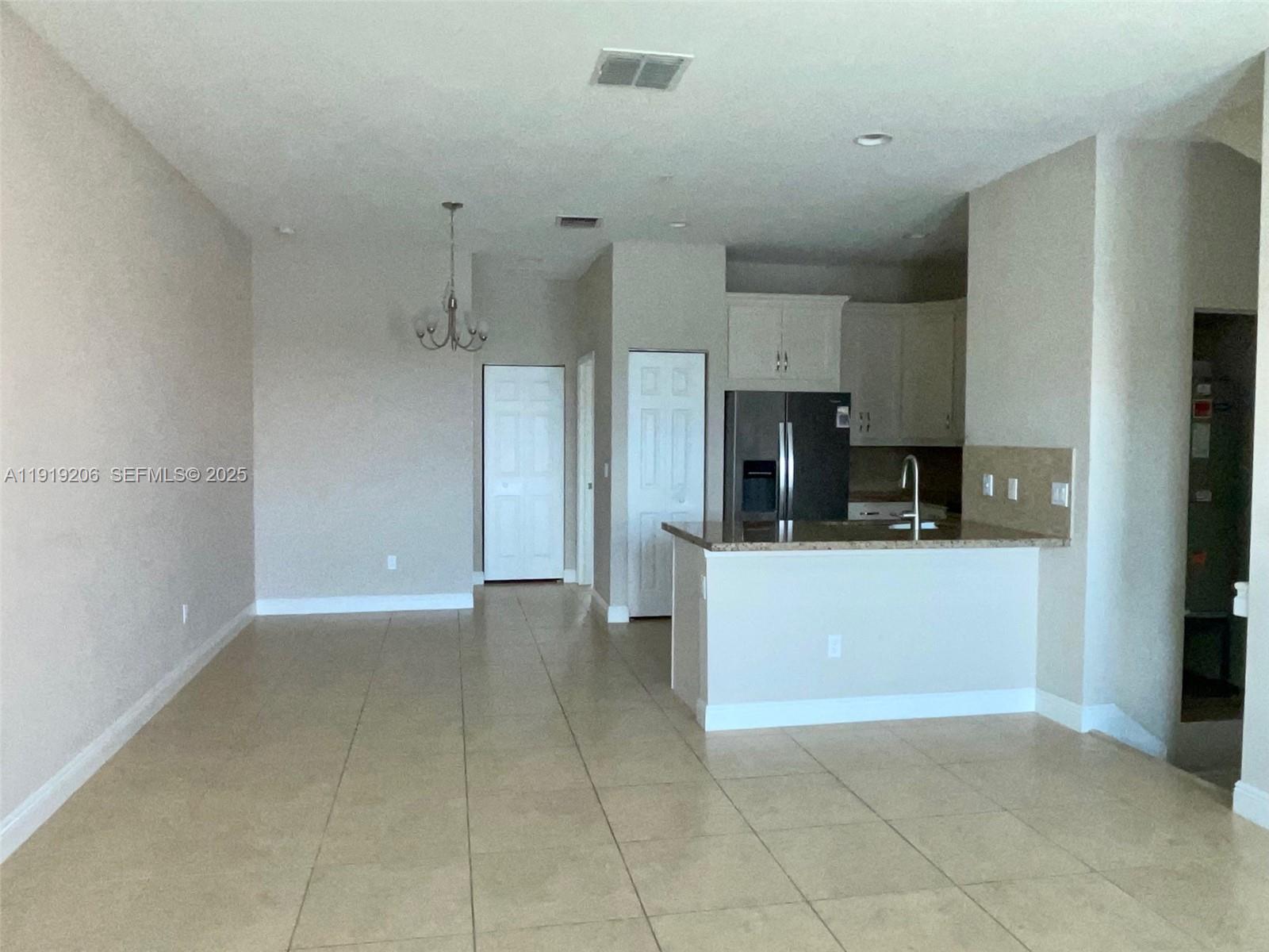 2929 Southwest 119th Way, Unit 2929 Miramar, FL 33025 - Photo 9 of 28 Kitchen with Stainless Steel Appliances & Dining/Family Area