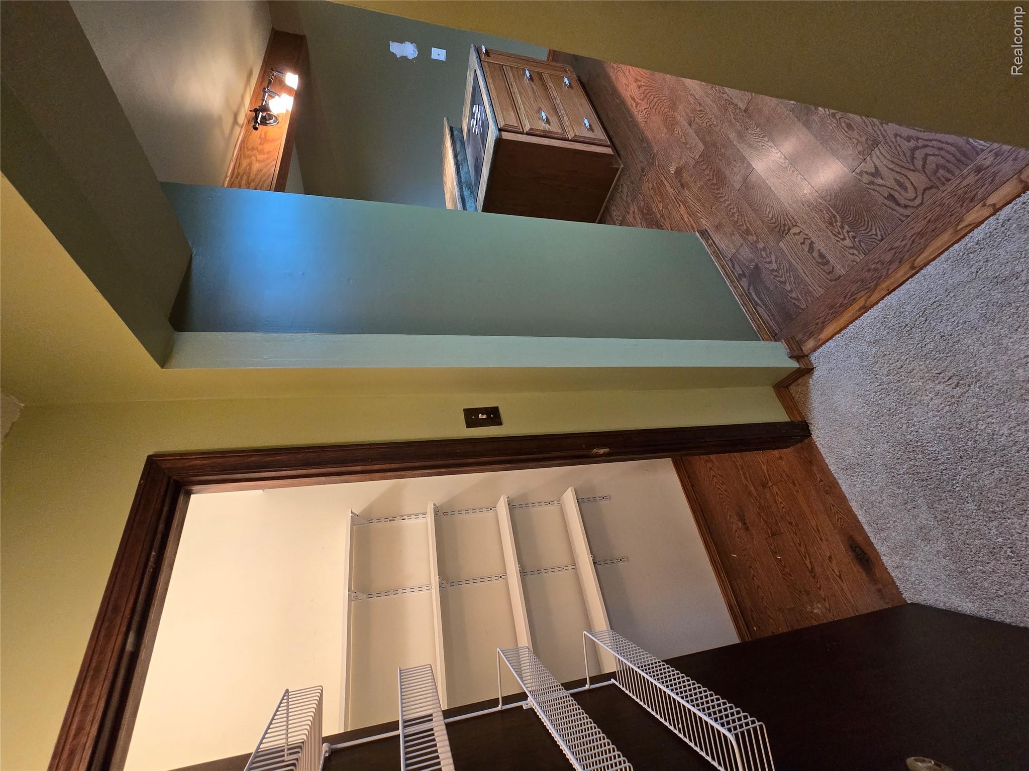 5282 McIntyre Road North Street, MI 48049 - Photo 23 of 53 Pantry with white wire shelving, wood-finish flooring, and a dark wood door frame