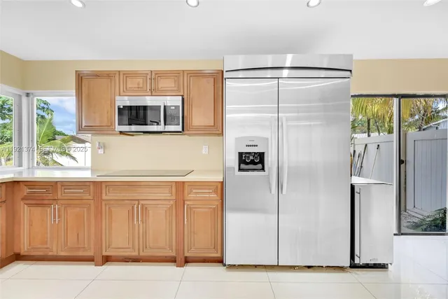 a kitchen with stainless steel appliances kitchen island granite countertop a sink and cabinets