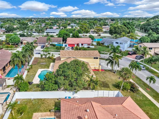 an aerial view of a house with a yard basket ball court and outdoor seating