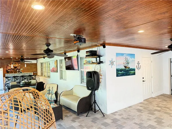 a bedroom with furniture a flat screen tv and a fireplace