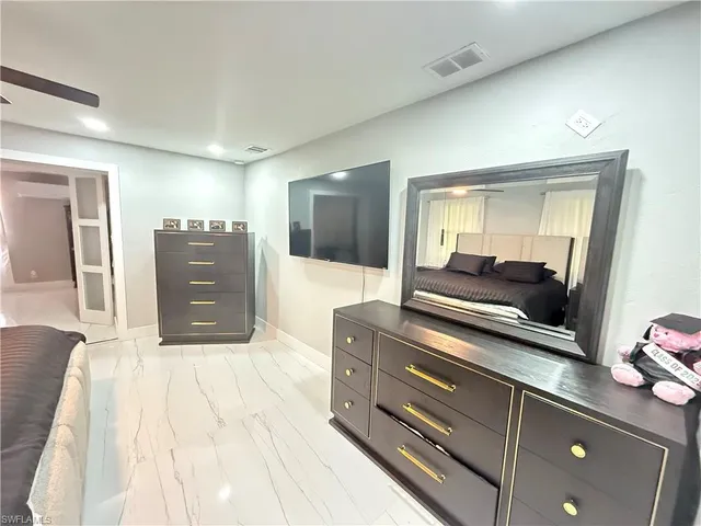 a room with a bed and a dresser