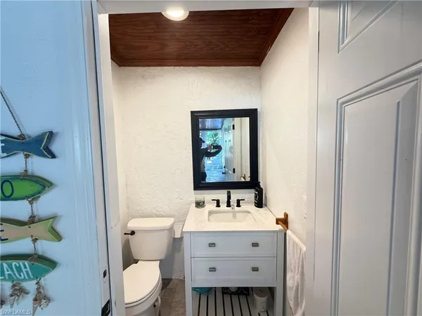 a bathroom with a sink mirror vanity and toilet