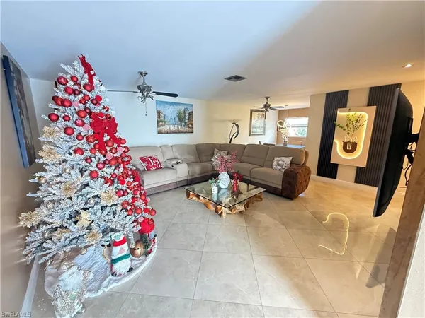 a living room with a couch and a potted plant