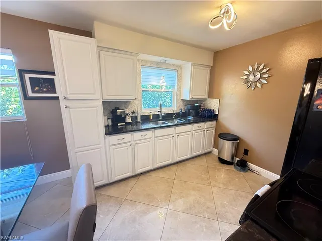 a kitchen with a sink cabinets and window